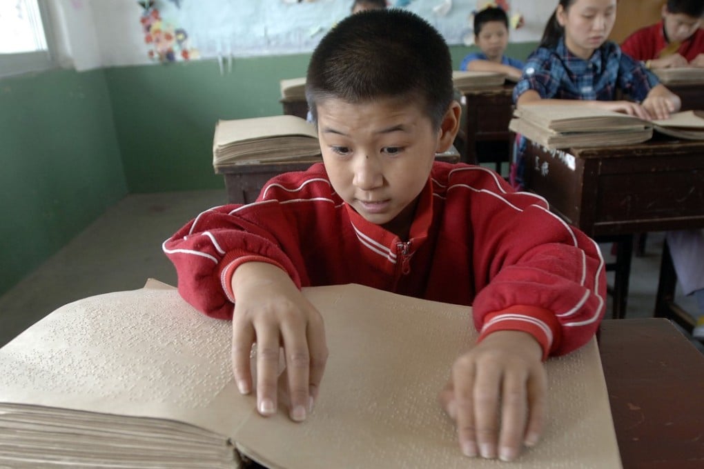 Children read Chinese Braille at a school for the blind in Hefei, Anhui province. Picture: AFP
