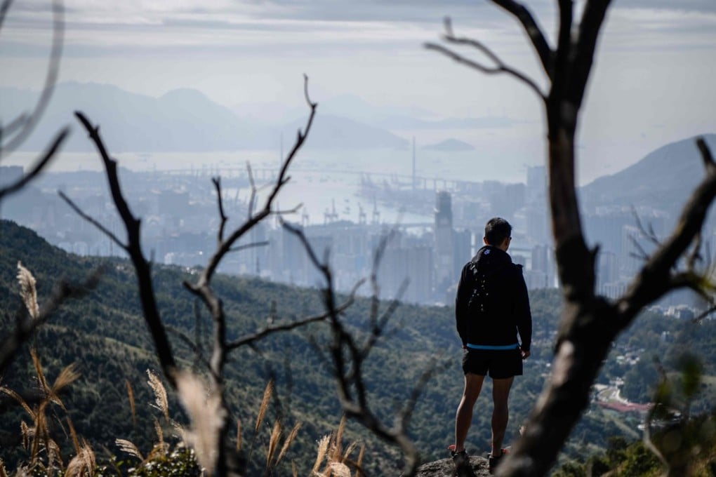 Trail runner Stone Tsang looks at the city from Hong Kong’s highest peak, Tai Mo Shan. Photo: AFP