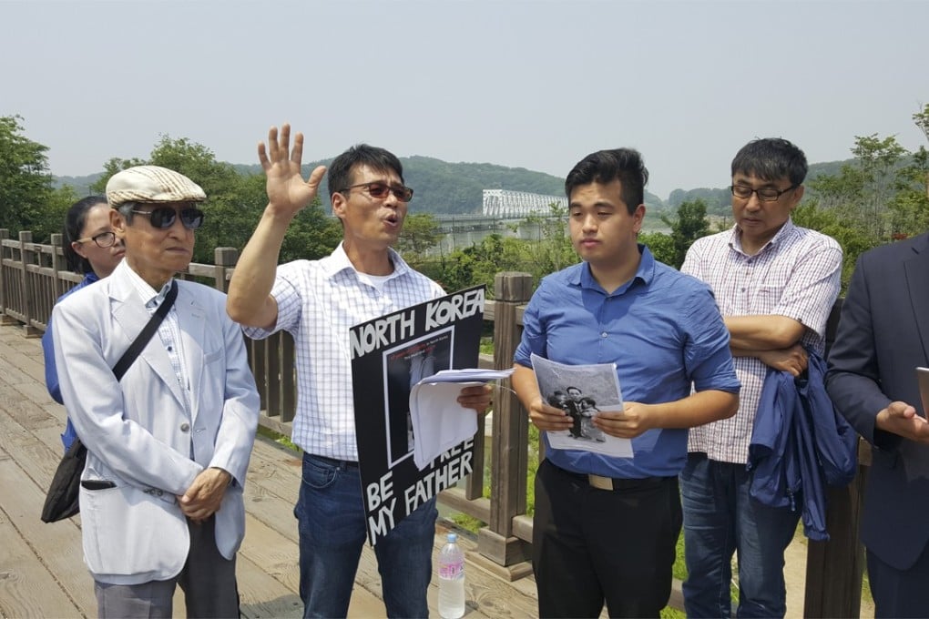 Hwang In-cheol (third left) on the Friendship Bridge in Panmunjeon with members of Seoul-based charity Teach North Korean Refugees and supporters in 2016 as he campaigns for his father’s return. Photo: Hwang In-cheol