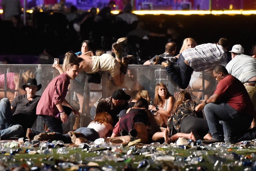 People scramble for shelter after gun fire was heard on October 1, 2017 in Las Vegas. Photo: AFP