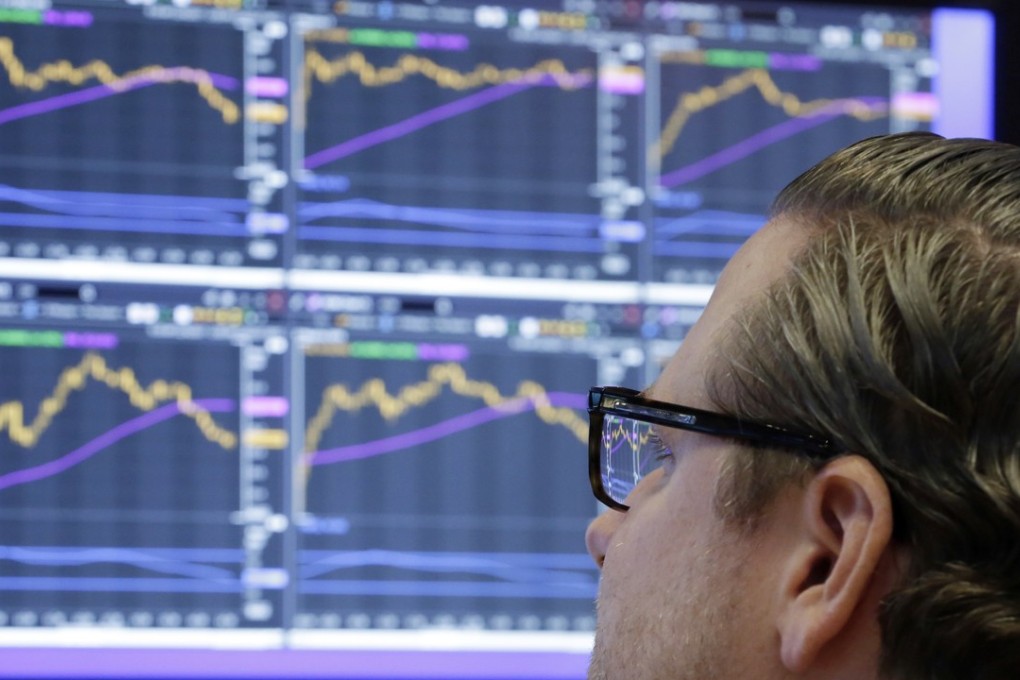 A specialist monitors prices from his post on the floor of the New York Stock Exchange. Global stock markets had a banner year overall in 2017, but current highs have left some concerned about an impending contraction. Photo: AP