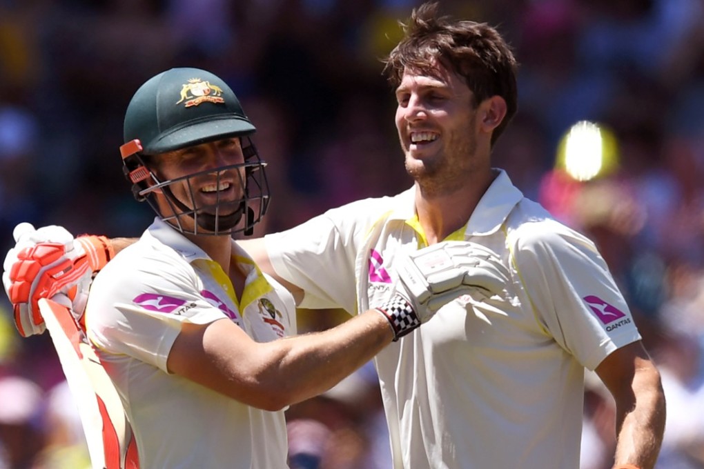 Australia's Mitch Marsh (right) celebrates scoring his century with brother Shaun. Photo: AFP