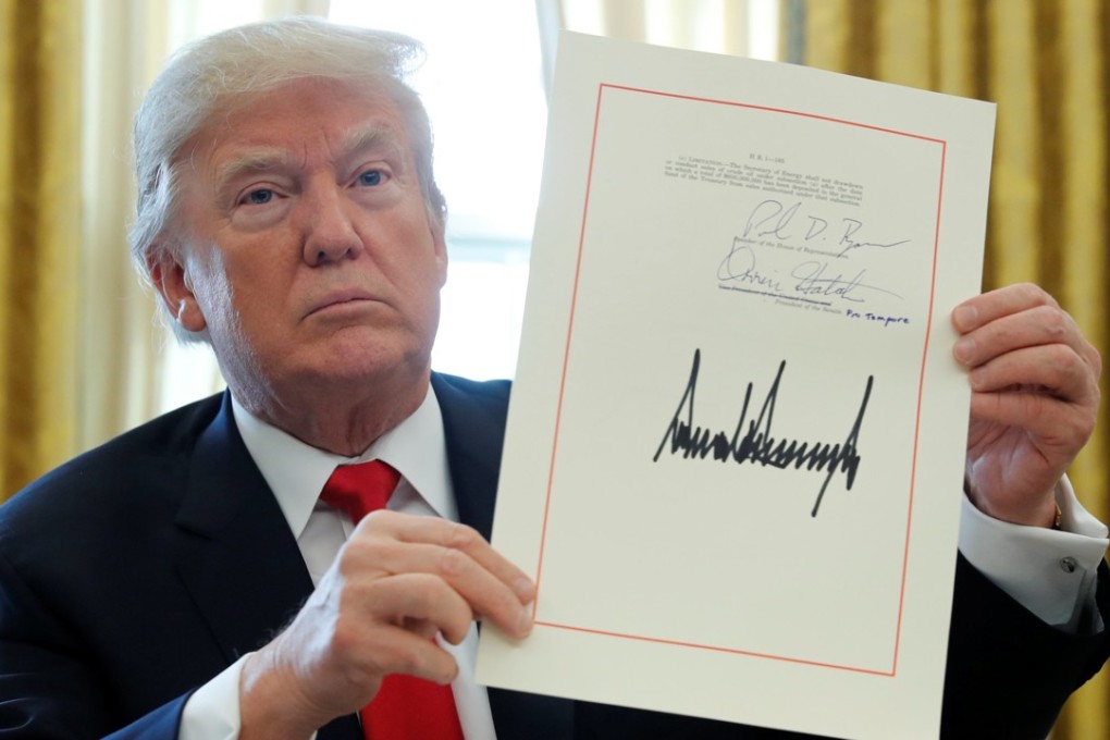 US President Donald Trump displays his signature after signing his hallmark US$1.5 trillion tax reforms in the Oval Office in Washington on December 22, 2017. Photo: Reuters