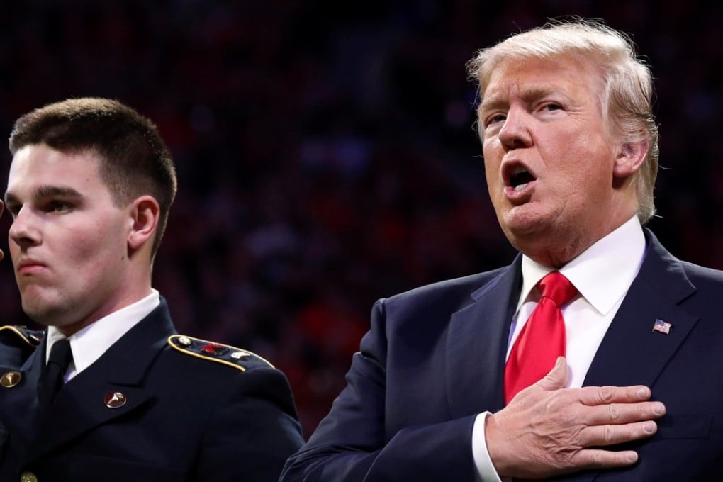 US President Donald Trump sings along with the US national anthem before the NCAA College Football Playoff Championship game between Alabama and Georgia in Atlanta on Monday. Photo: Reuters