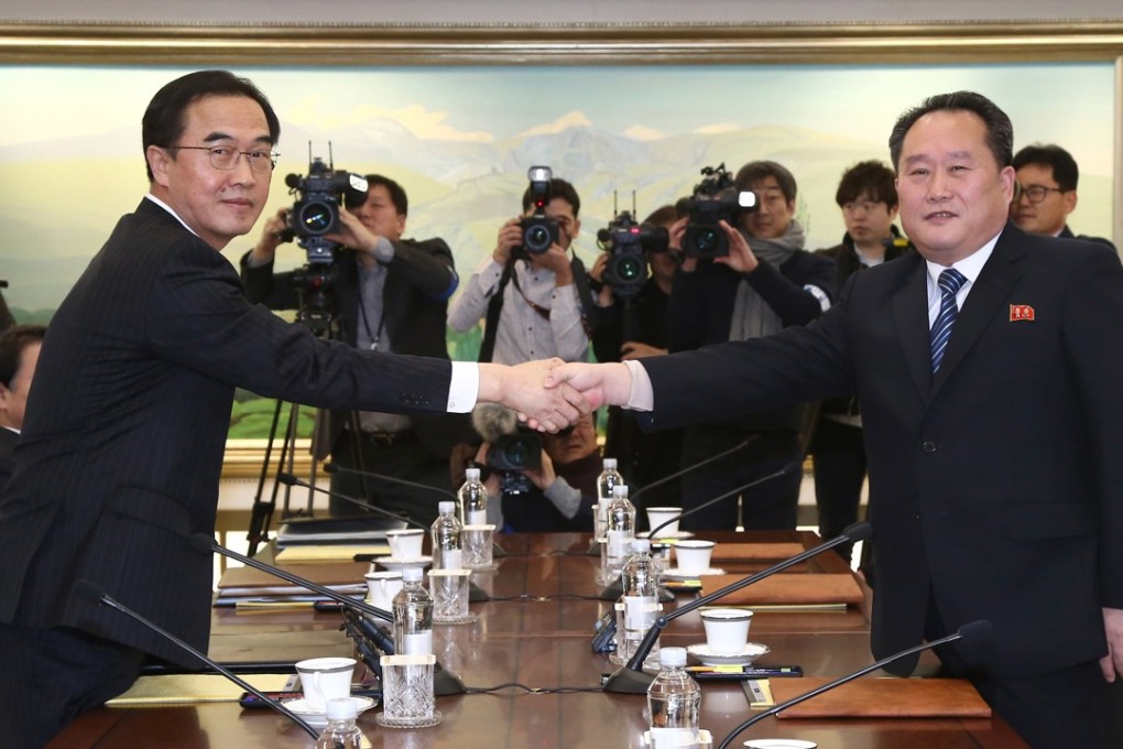 South Korean unification minister Cho Myoung-gyon poses with head of the North Korean delegation Ri Son-gwon during their meeting at the Panmunjeom in the demilitarised zone. Photo: AP
