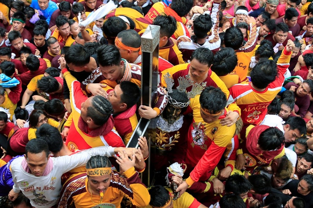 Devotees jostle to reach the carriage of the Black Nazarene during the annual procession in Manila, Philippines. Photo: Reuters