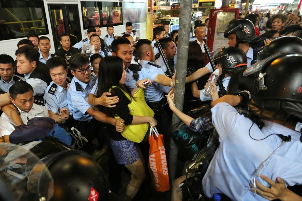 Police officers clash with pro-democracy protesters during a clearance operation on Nathan Road in Mong Kok in 2014. Photo: Sam Tsang