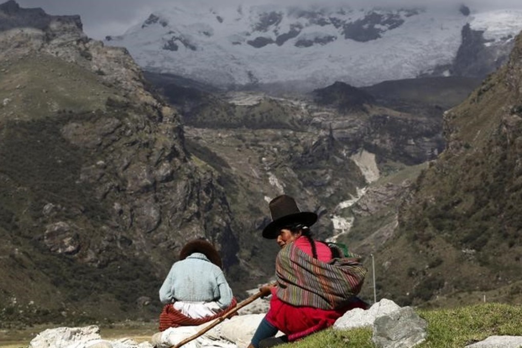 Shepherdess Narcisa Cornelio (R) and her daughter Nancy Condor rest in front of Hualcan glacier in Huascaran natural reserve in Ancash, Peru. The country’s glaciers are shrinking in the face of climate change, and the country is reviving old techniques to keep the land alive File photo: Reuters