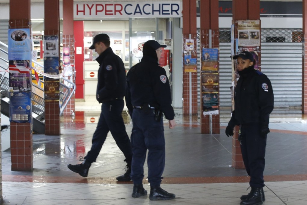 French police patrol outside the kosher market in Creteil, south of Paris, after a fire broke out on the anniversary of the 2015 terrorist attacks. Photo: AP