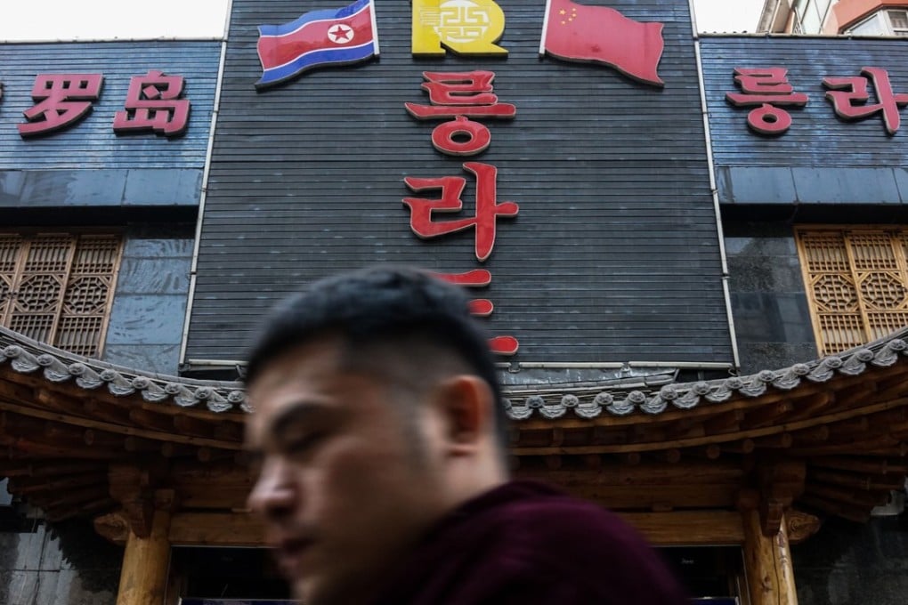 A man walks past a North Korean restaurant in Shenyang, Liaoning. Beijing set a deadline of January 9 for North Korean businesses in China to close. Photo: AFP