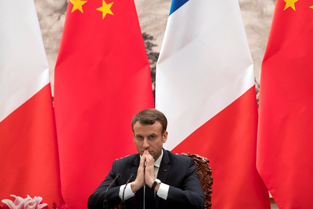 French President Emmanuel Macron watches a signing ceremony between French and Chinese firms at the Great Hall of the People in Beijing on Tuesday. Photo: Reuters
