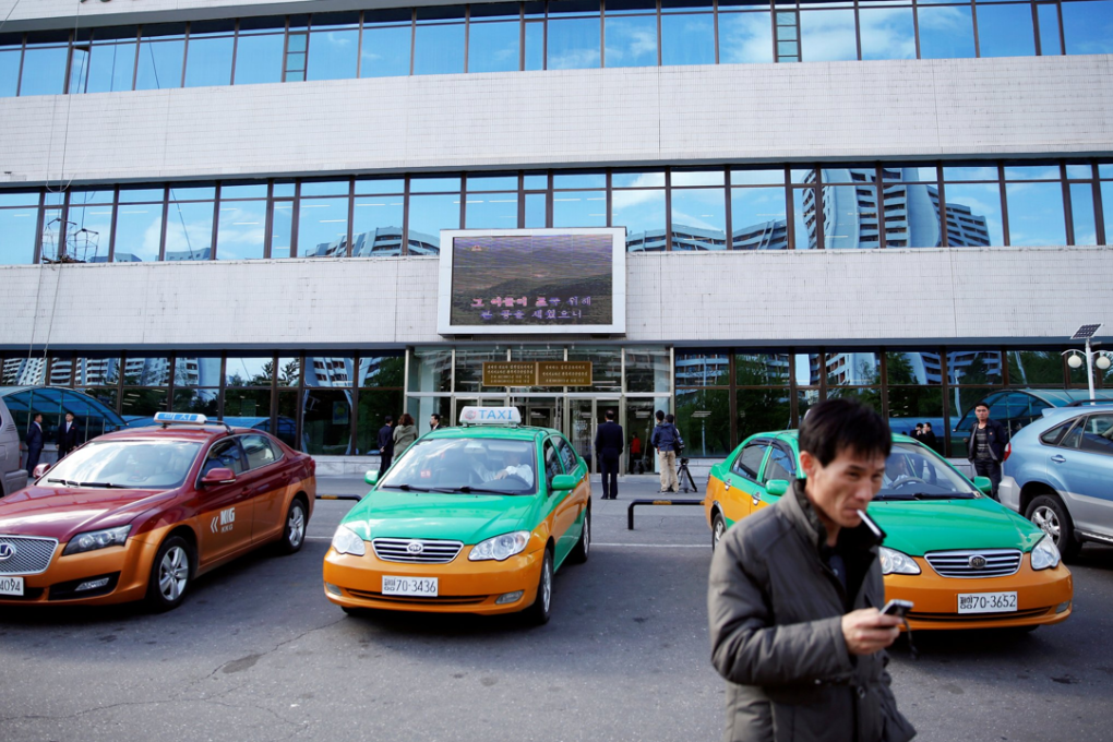 Taxis are parked outside a department store in central Pyongyang, North Korea May 4, 2016. Photo: REUTERS/Damir Sagolj