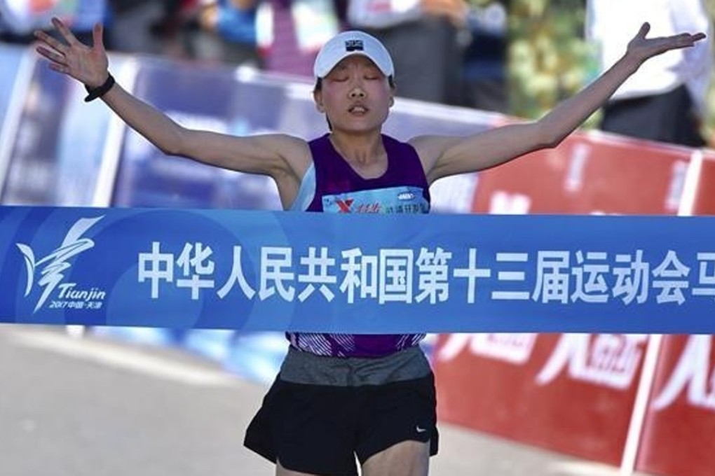 Wang Jiali crosses the finish line to win the women's marathon at the 2017 National Games. Photos: Xinhua