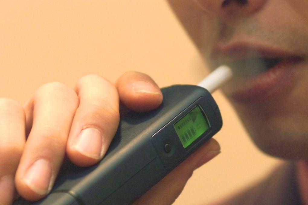 A smoker demonstrates the heat-not-burn smoking technology, which a Japanese man was used to poison another man with mercury. Photo: AP