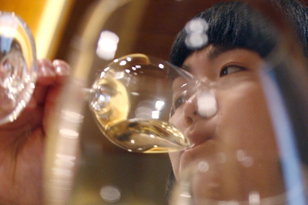 A woman drinks white wine during a wine-tasting event in Beijing. Technology start-up eDaijia, which runs a popular mobile app that links inebriated car owners with substitute drivers, has terminated a service that allowed users to summon surrogate drinkers. Photo: Reuters