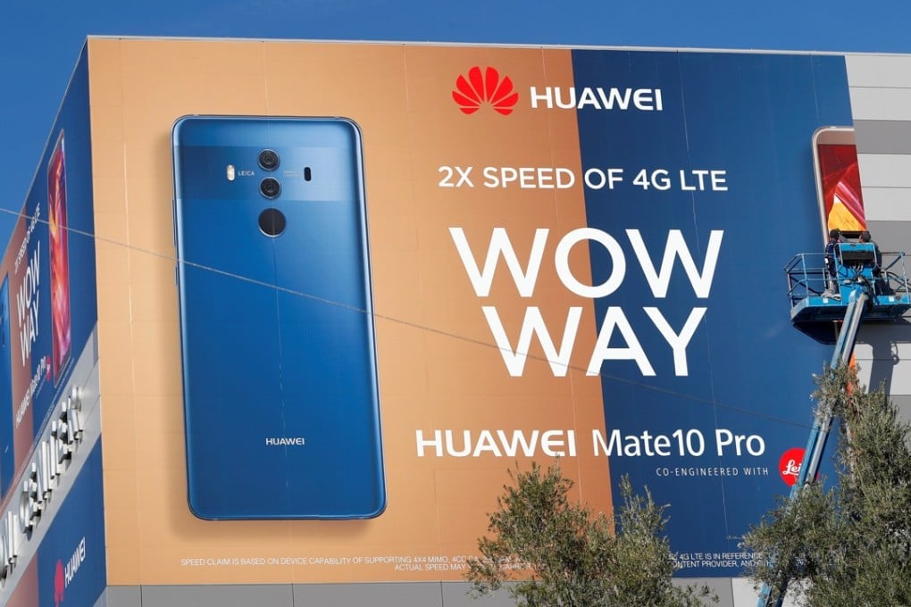 A crew hangs a Huawei advertising banner on the side of the Las Vegas Convention Centre as workers prepare for the 2018 CES in Las Vegas this week. Photo: Reuters