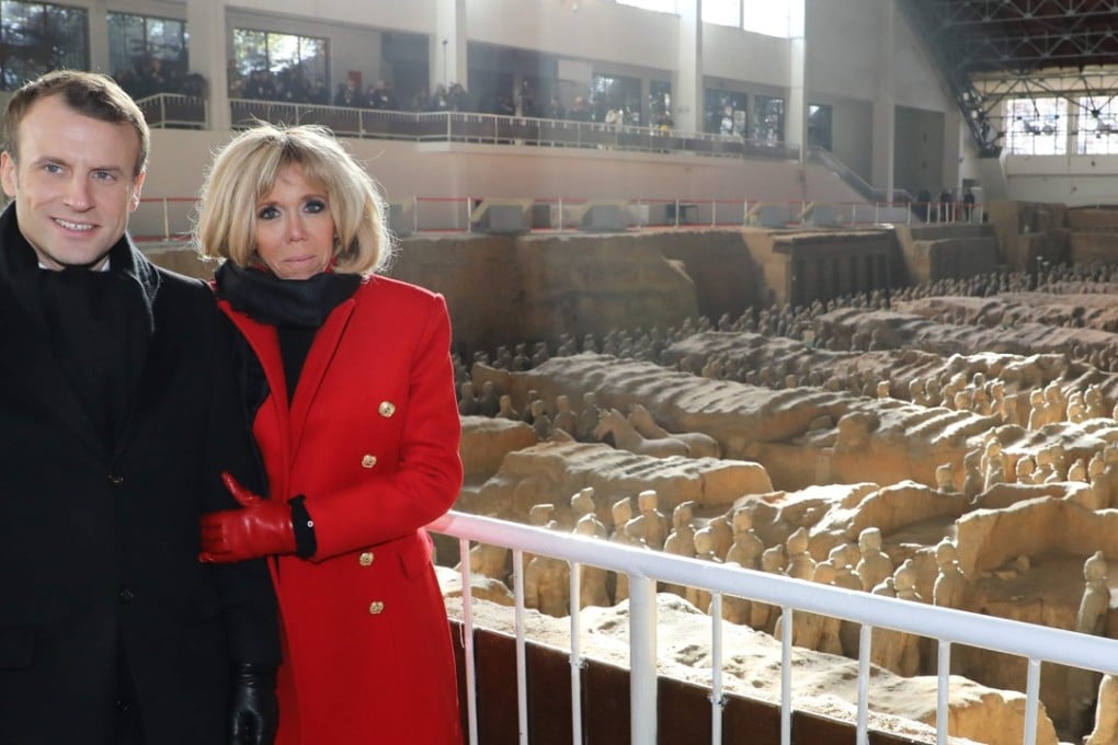 French President Emmanuel Macron and his wife, Brigitte, who wore a red coat from Parisian label Balmain for a visit to Xian’s terracotta warriors museum this week. Photo: AFP/Pool