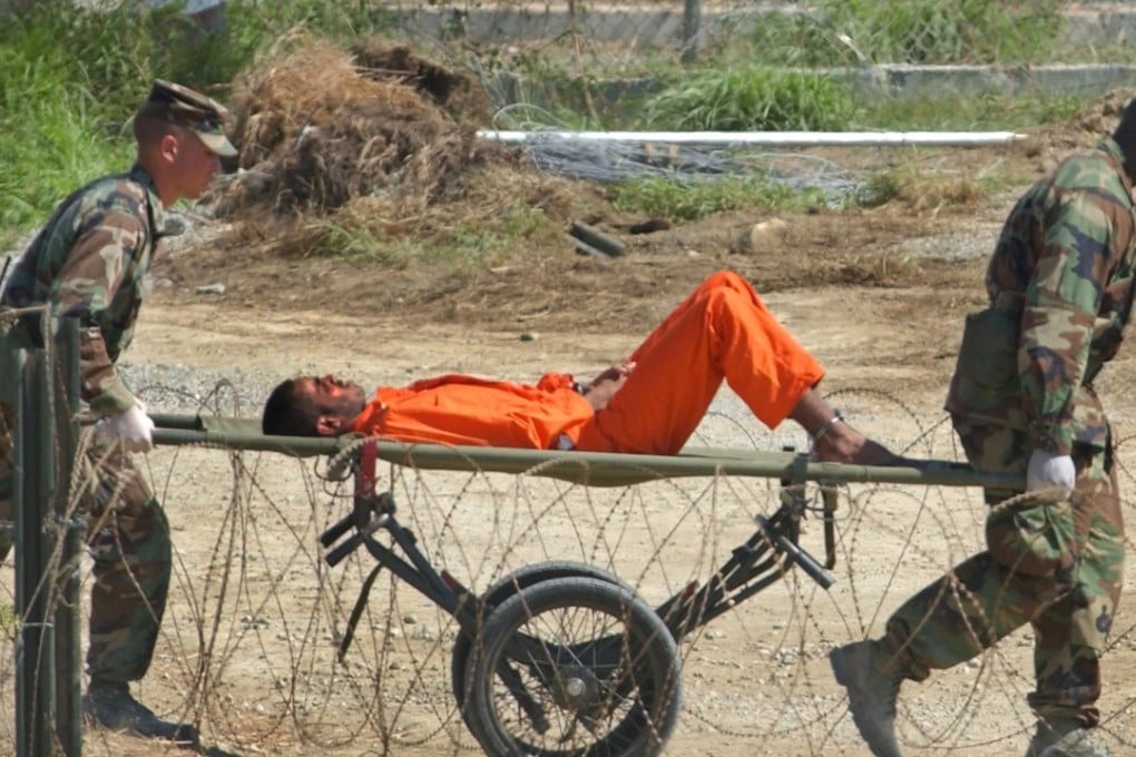 A detainee from Afghanistan is wheeled on a stretcher before being interrogated by military officials at the Guantanamo Bay US Naval Base in Cuba in 2002. Photo: AP