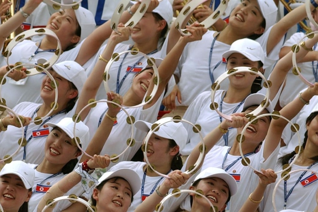 North Korean cheerleaders wave during the North Korea against Germany women's football match in Gimcheon Stadium in 2003. File photo: AFP