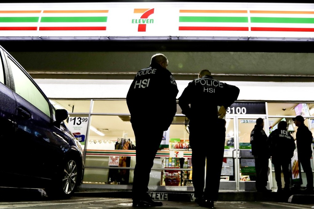 US Immigration and Customs Enforcement agents raid a 7-Eleven convenience store on Wednesday in Los Angeles. Agents said they targeted about 100 7-Eleven stores nationwide in a crackdown against illegal workers. Photo: AP