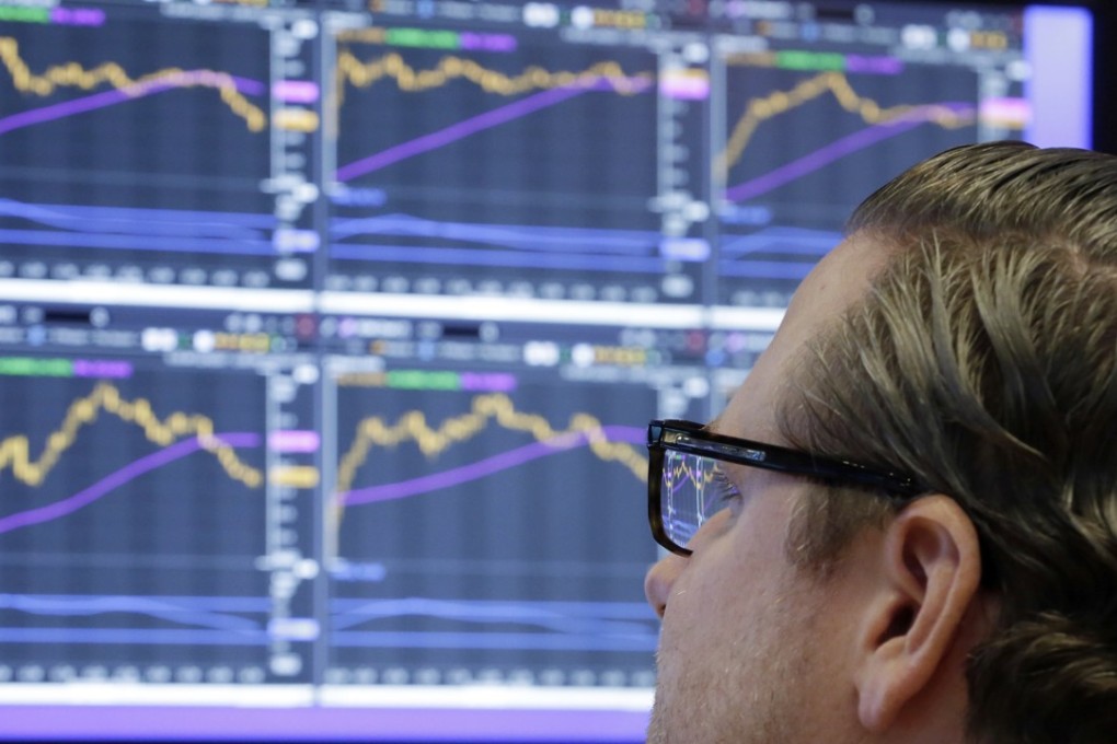 A trader on the New York Stock Exchange. Stock markets had a good year overall in 2017, and many major ones have started this year positively. Investment company Invesco says this situation is likely to continue as interest rates remain low. Photo: AP
