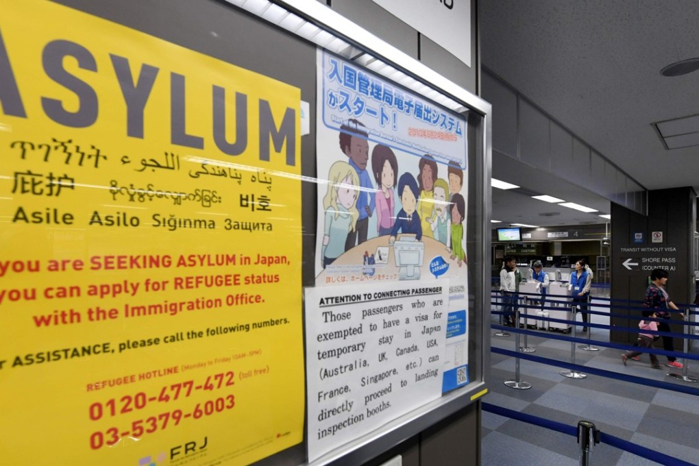 A poster for asylum seekers near the passport control counter of the immigration office at the Narita International airport in Narita. Japan is set to tighten its refugee screening system on Monday. Photo: AFP