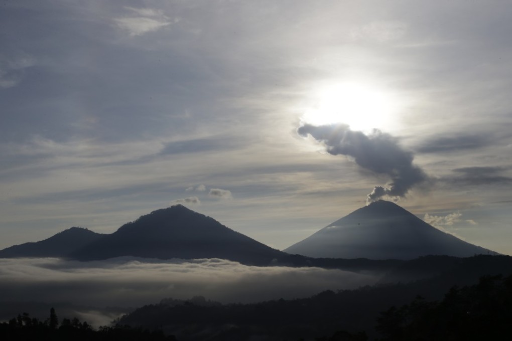 Mount Agung (seen in December; photo from latest eruption below) belched ash into the air on Thursday. It has been intermittently erupting since November. Photo: AP