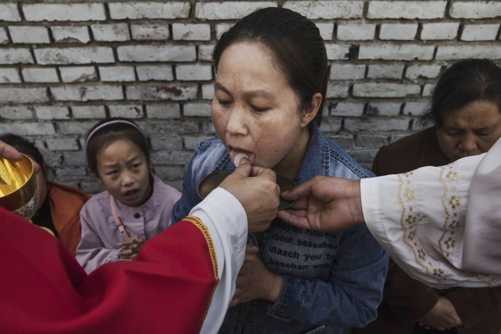 A woman takes communion at a mass at an underground Catholic church near Shijiazhuang, Hebei province. Photo: AFP