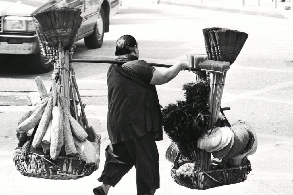A hawker carries cleaning products for sale in Sai Ying Pun in 1985.