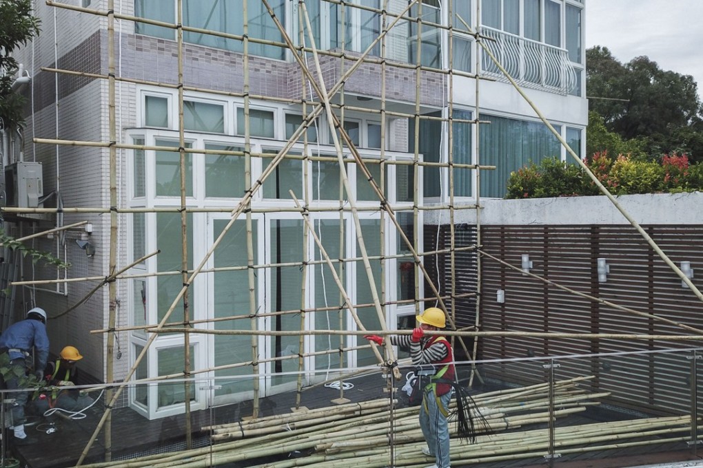 Workers setting up scaffolding at Teresa Cheng’s home in Siu Lam, Tuen Mun, on Wednesday. Photo: Winson Wong