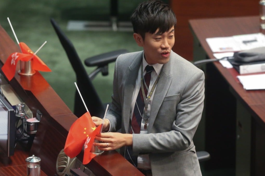 Legislator Cheng Chung-tai turns the flags upside down in the Legco chamber in 2016. Photo: K.Y. Cheng