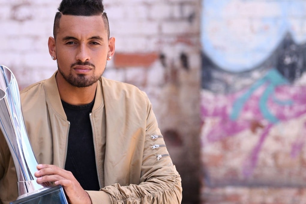Nick Kyrgios poses with the trophy after his victory in Brisbane International final. Photo; AFP