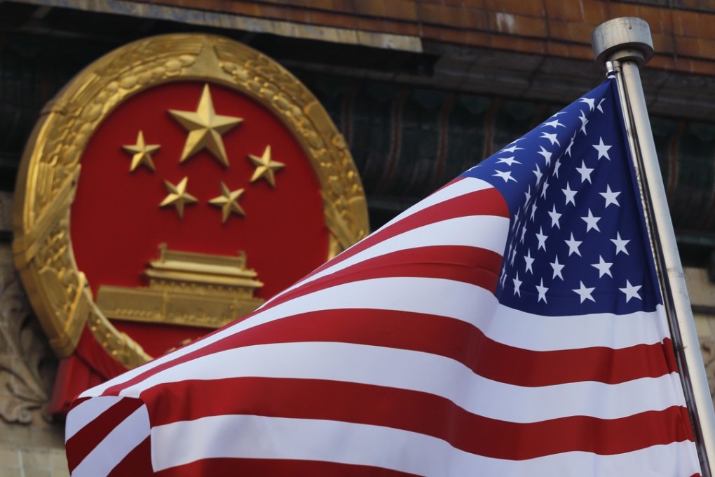 An American flag next to the Chinese national emblem during a welcome ceremony for visiting U.S. President Donald Trump outside the Great Hall of the People in Beijing on November 9, 2017.Photo: AP