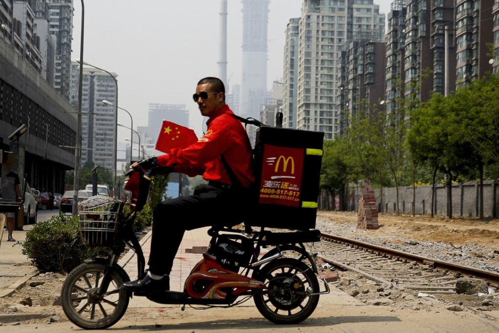 A McDonald's delivery man in Beijing. Last year, deliveries accounted for a quarter of the sales in tier one cities for the fast-food chain. Photo: AP