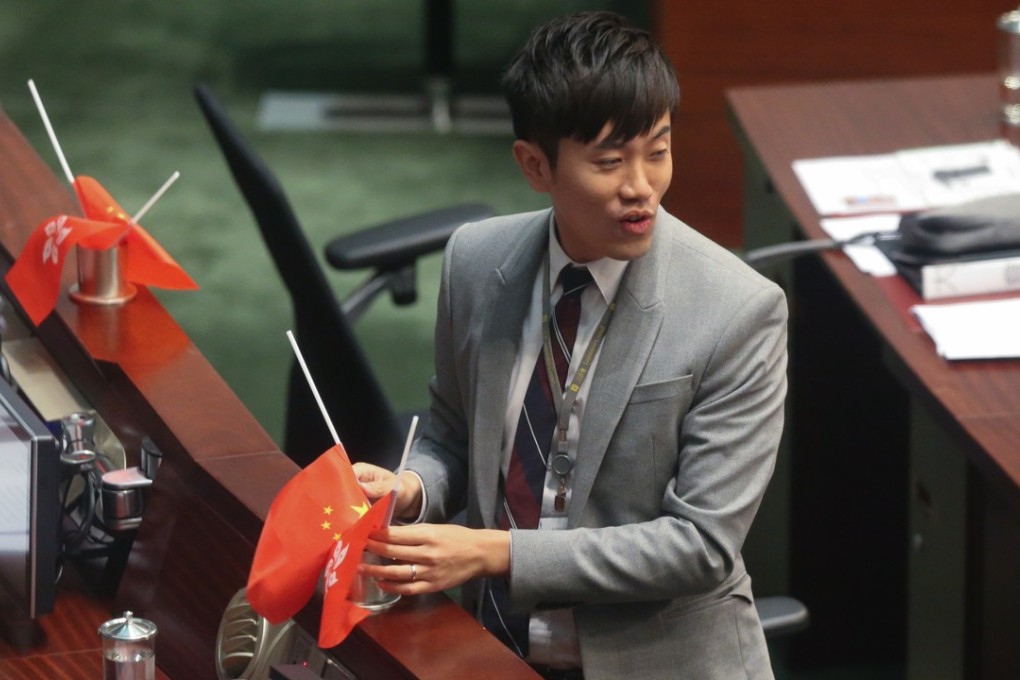 Legislator Cheng Chung-tai turns the flags upside down in the Legco chamber in 2016. Photo: K.Y. Cheng