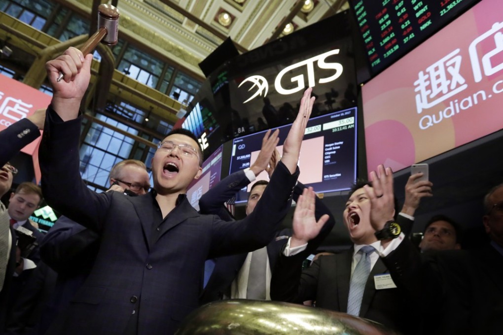 Qudian CEO and founder Min Luo rings the ceremonial bell on the New York Stock Exchange as the company’s shares begin trading on October 18. Photo: AP