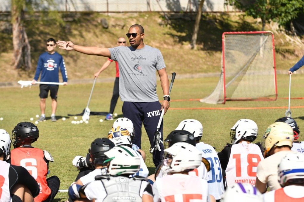 Kyle Harrison teaches young lacrosse players how to shoot.