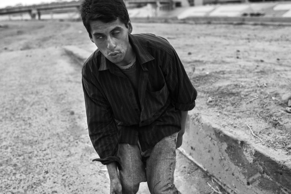Cesar Corona stumbles after injecting a “Belushi,” a combination of methamphetamine and heroin, into his neck at El Bordo, a desolate area populated by addicts and the homeless in Tijuana, Mexico. Corona, 27, says he has been addicted to methamphetamine and heroin since his mother committed suicide when he was 18. Photo: Washington Post