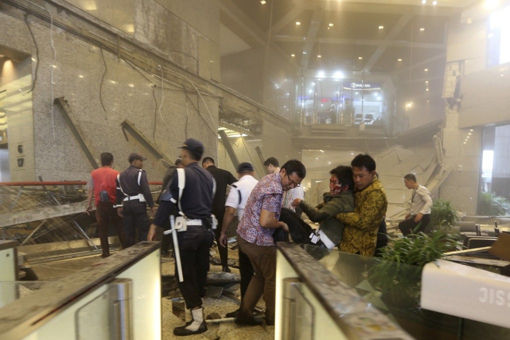 An injured man is carried out of the Jakarta Stock Exchange tower after a floor collapsed, injuring dozens. Photo: AP