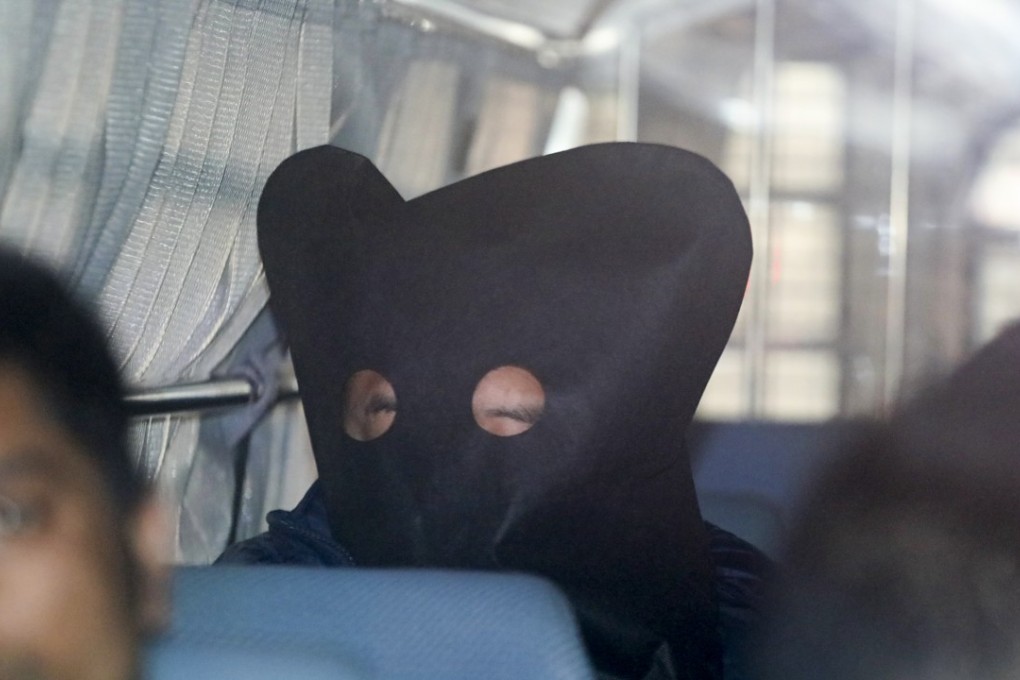 Kim Min-ho (hooded) is escorted to Kowloon City Court. Photo: Handout