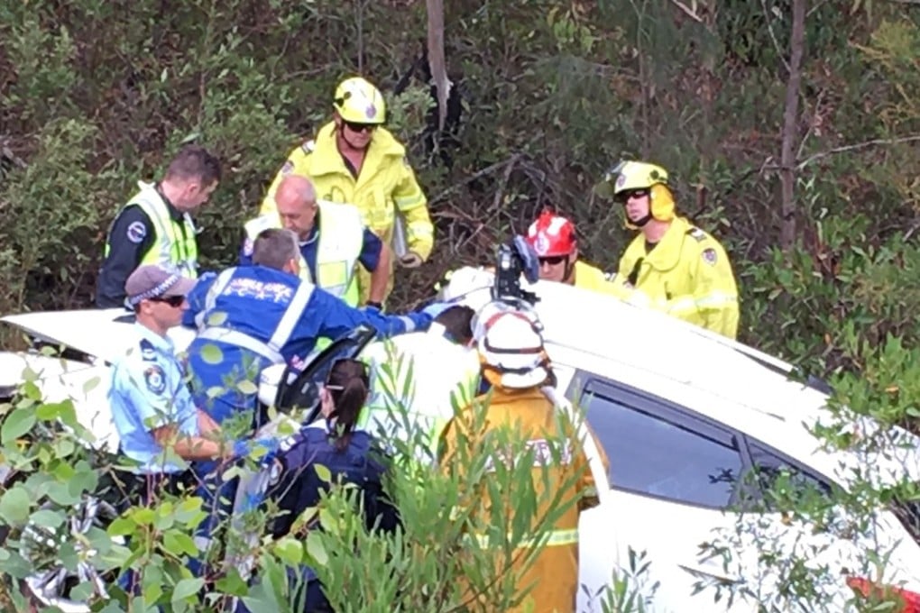 Rescuers work to free Samuel Lethbridge, 17, who was trapped in his car for 30 hours before his father found him by renting a helicopter. Photo: AP