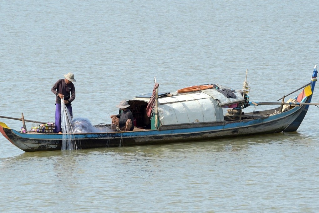 A Cambodian fisherman pulls his net in the Mekong – a massive river that feeds tens of millions but is under threat from Chinese dams. Photo: AFP