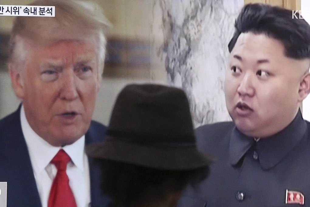 A Seoul resident passes a television screen showing US President Donald Trump and North Korean leader Kim Jong-un. Photo: AP