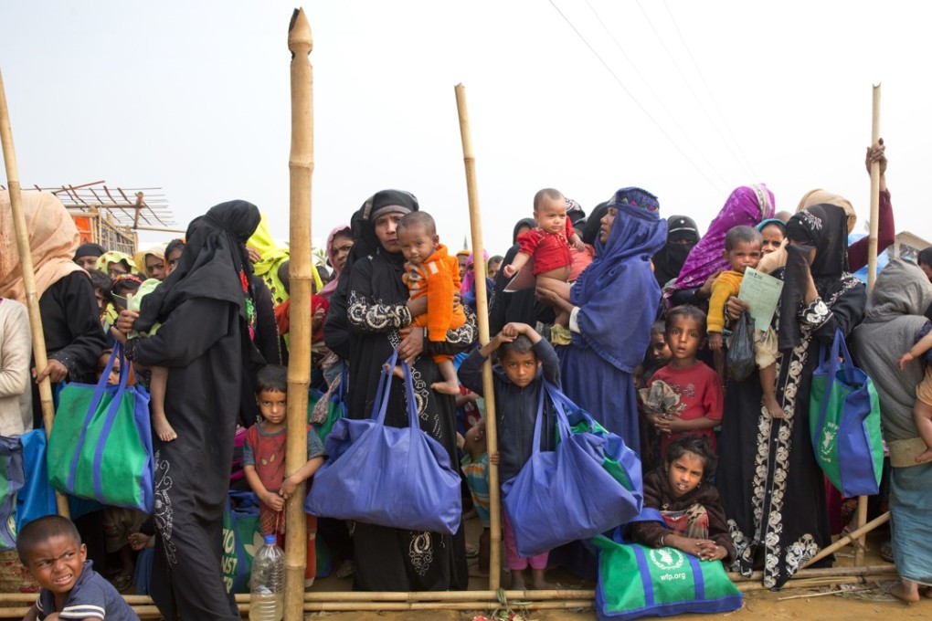 Rohingya Muslim women with their children stand in a queue outside a food distribution centre at a refugee camp near Cox's Bazar, Bangladesh. Myanmar has agreed to repatriate the refugees within two years. Photo: AP