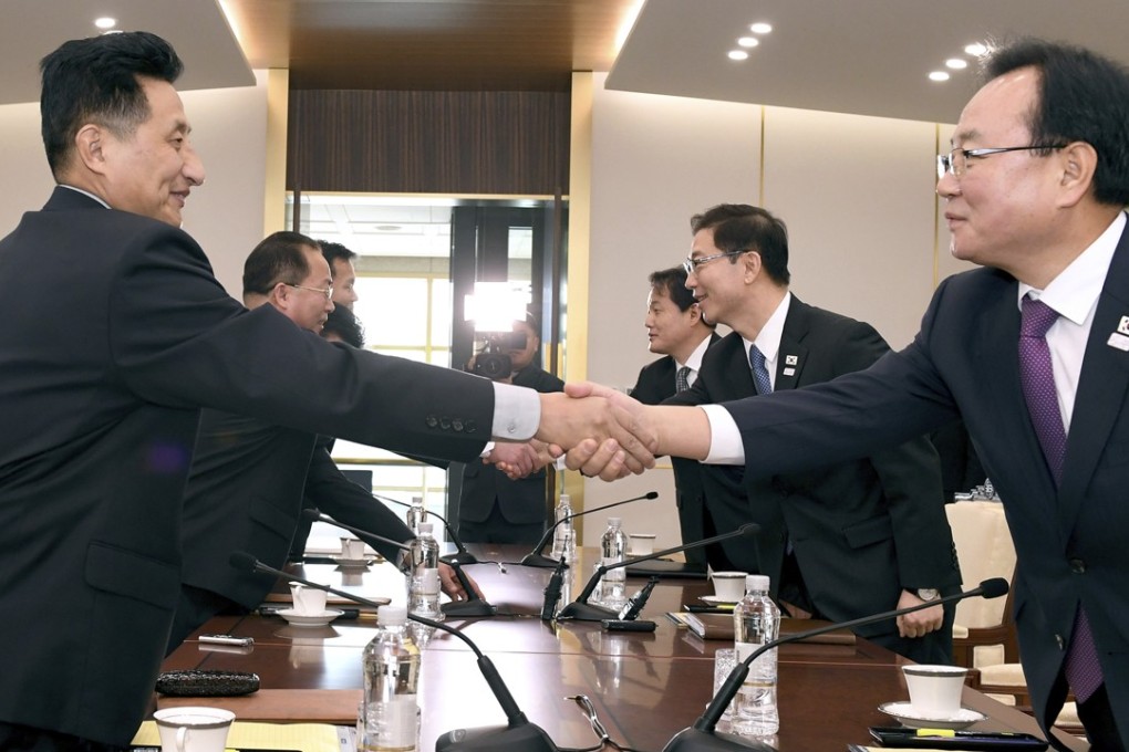 South Korean officials led by the vice-minister for unification Chun Hae-sung (centre right) shake hands with the North Korean delegation during their meeting at Panmunjom in the demilitarised zone in Paju, South Korea, on January 17. Photo: South Korean Unification Ministry via AP