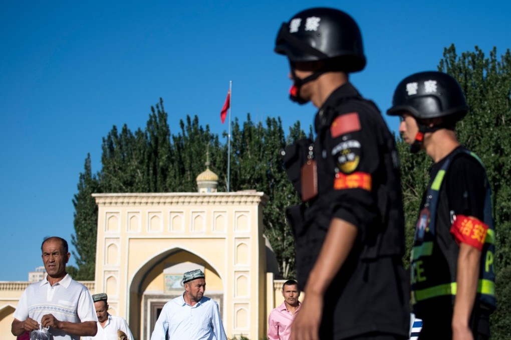 Police patrol the streets as Muslims leave the Id Kah Mosque after the morning prayers in Kashgar, in China’s Xinjiang Uygur autonomous region, in July 2017. Photo: AFP