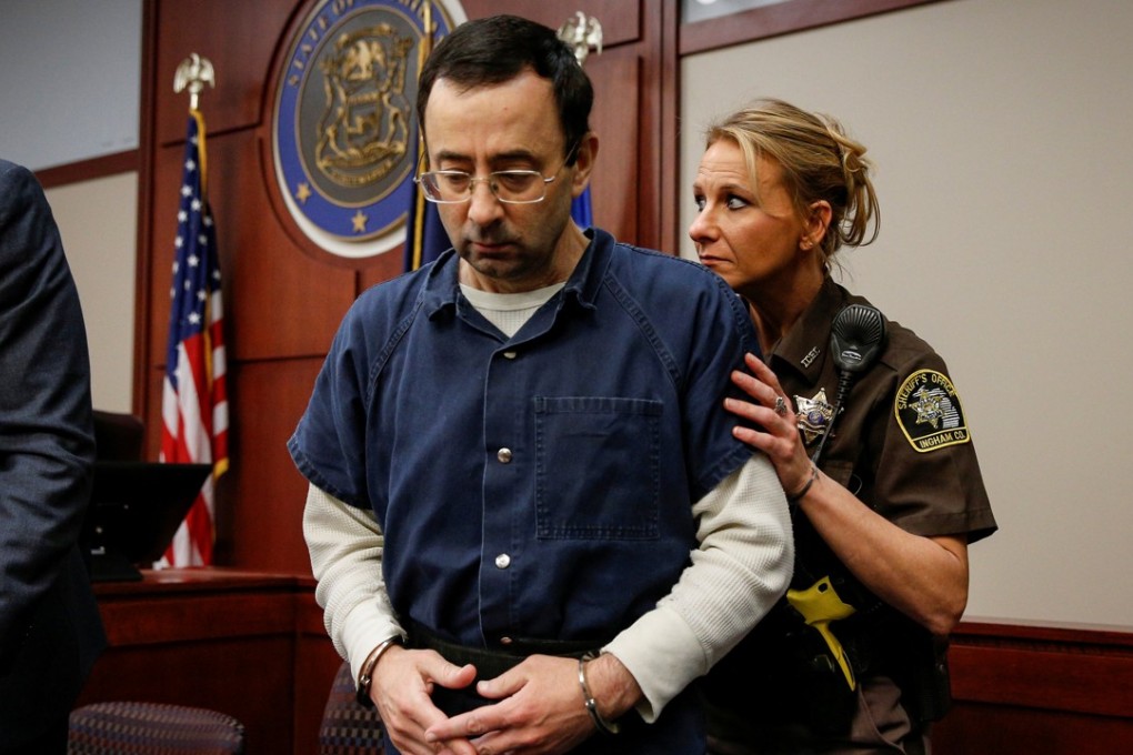 Larry Nassar, a former Team USA gymnastics doctor who pleaded guilty in November 2017 to sexual assault charges, is escorted by a court officer during his sentencing hearing in Lansing, Michigan. Photo: Reuters