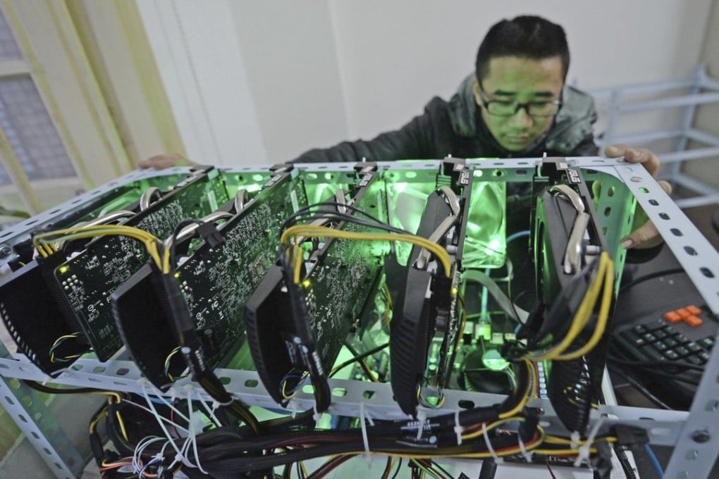 In this December 6, 2013 photo, a staff member checks a bitcoin mining computer at Landminers in Chongqing. China is home to the world’s largest cryptocurrency mines, eager to make use of the country’s abundantly cheap electricity charges. Photo: Chinatopix