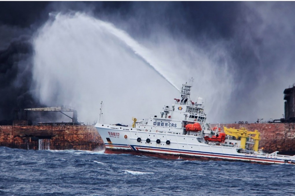 A Chinese firefighting vessel sprays foam on the burning oil tanker off the eastern coast of China. Photo: AFP