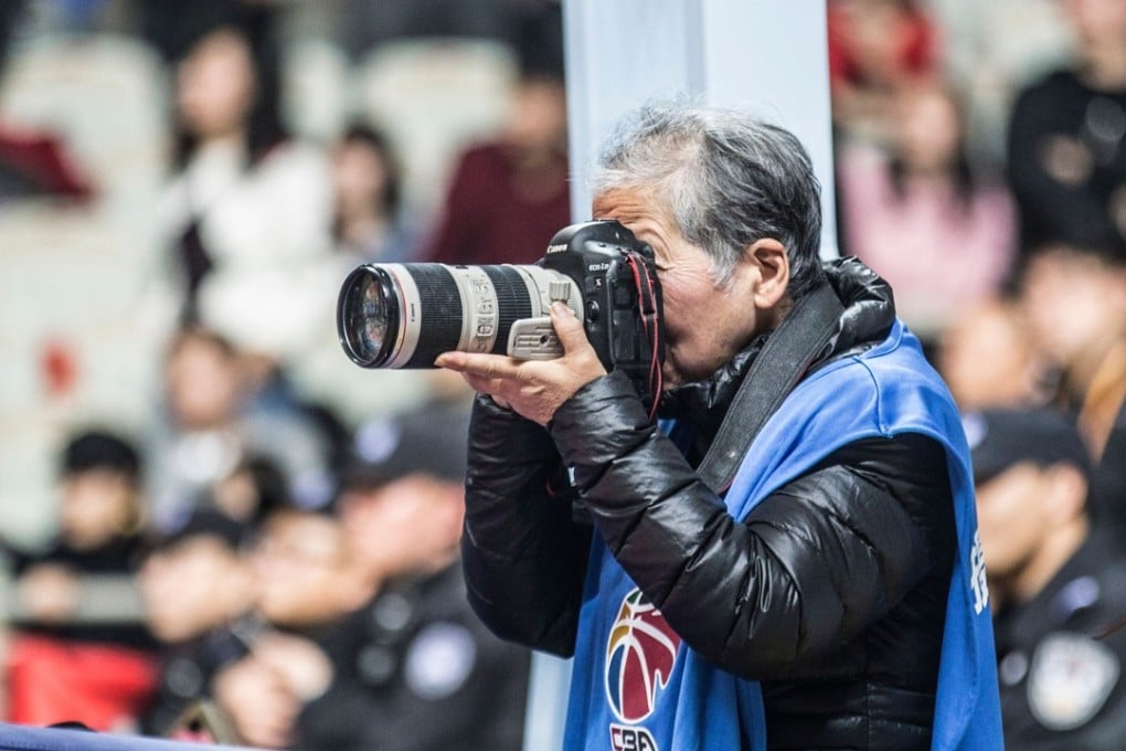 Hong Nanli pictured taking pictures during a basketball match in Shanghai this month. Photo: Agence France-Presse